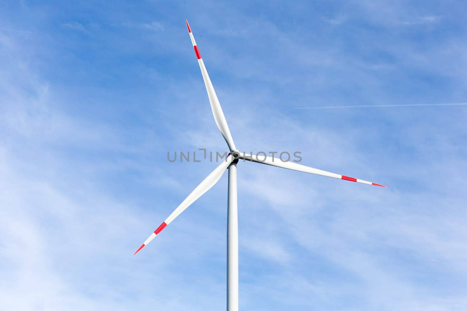 The windmill with a blue sky in the background