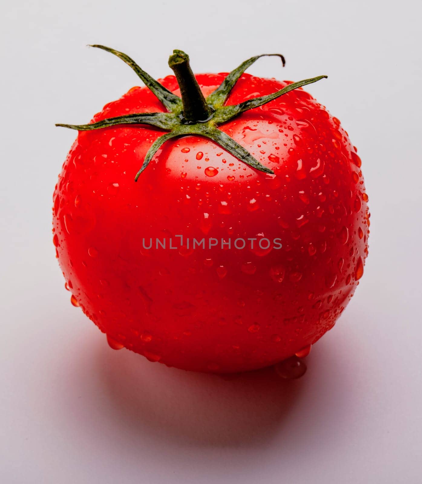 Wet juicy tomato on isolated on white