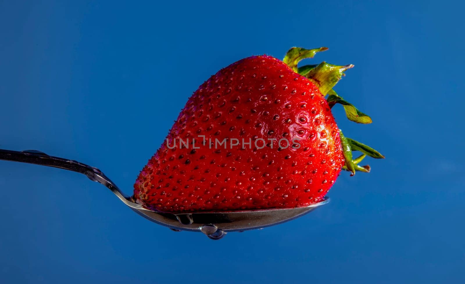Strawberry on a spoon, washed and ready to eat