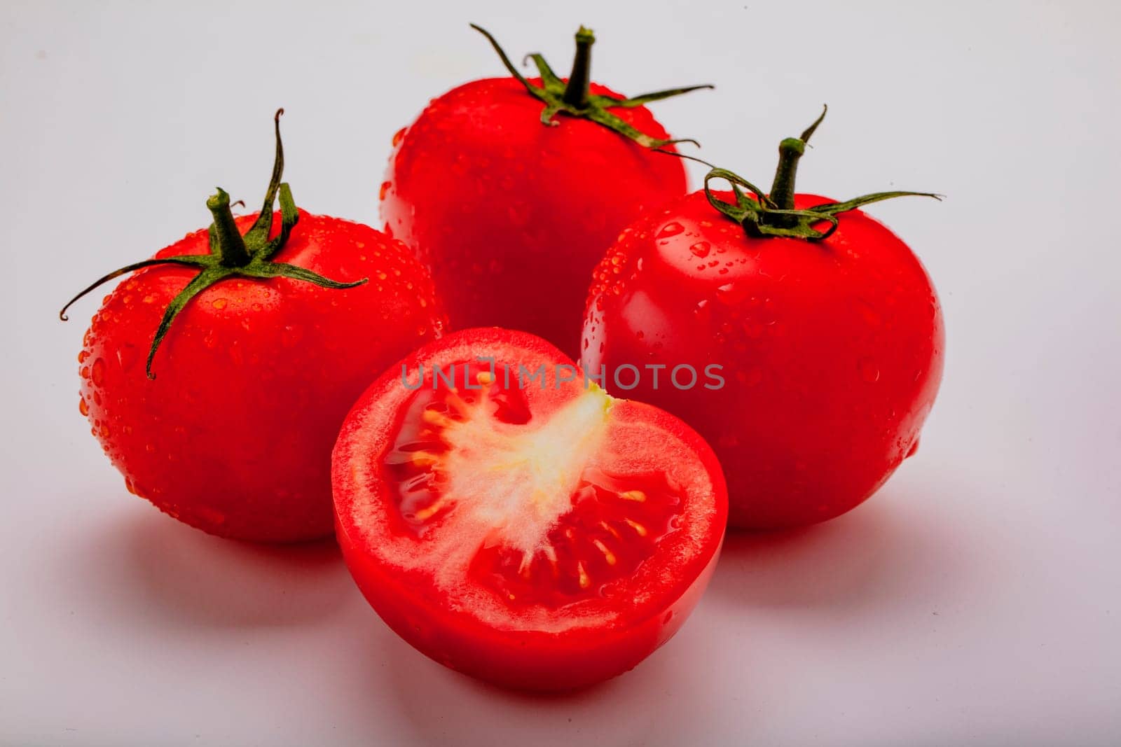 Three wet tomatoes plus one cut open
