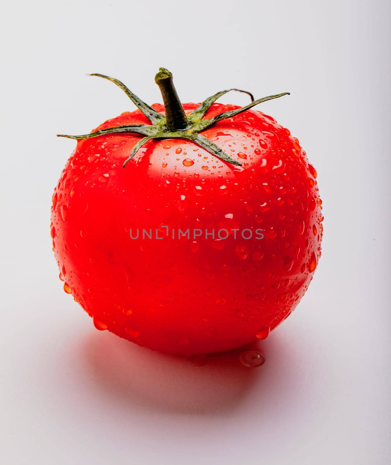 Wet juicy tomato on isolated on white