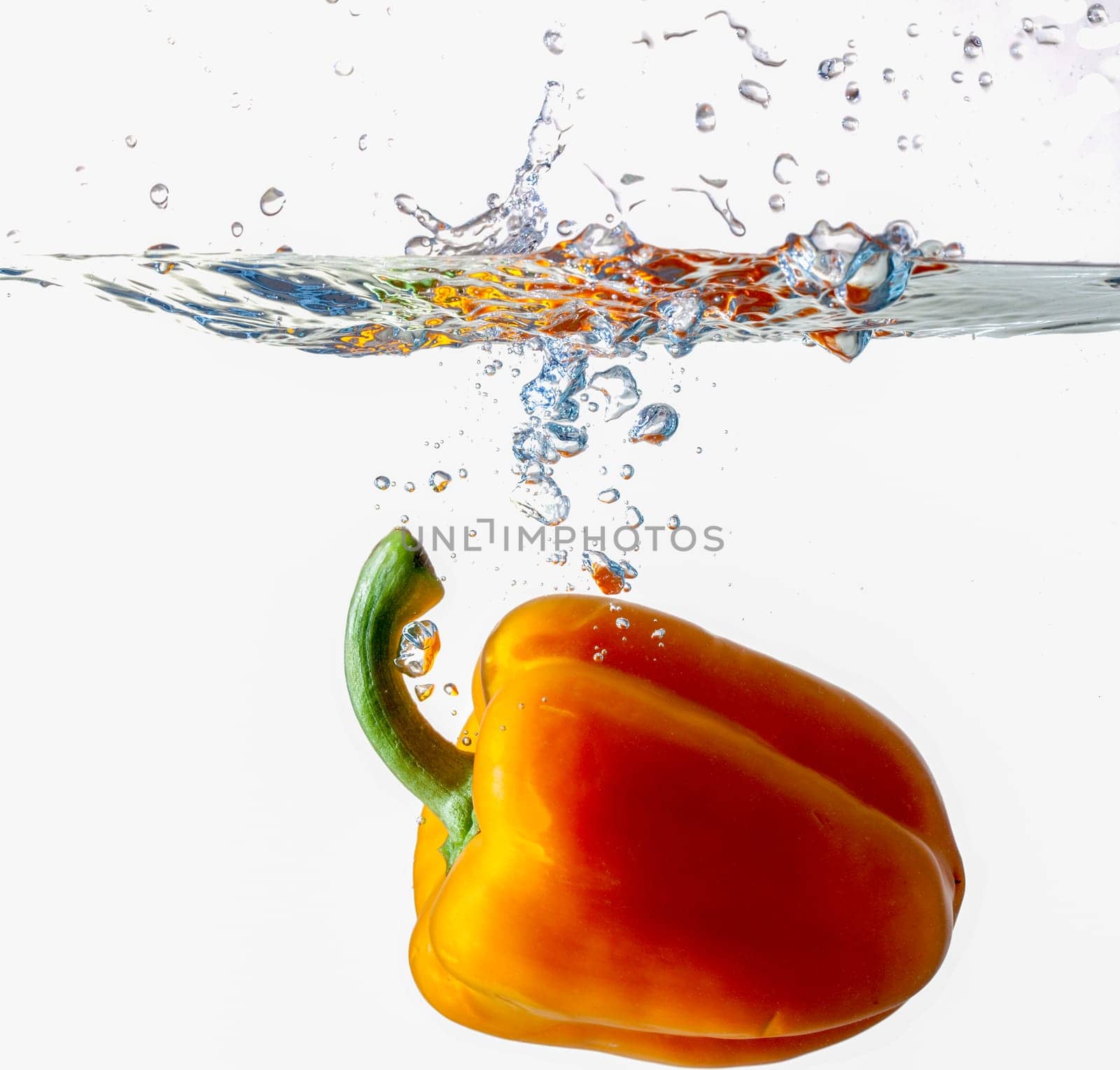 Orange Bell Pepper Dropping Into Water