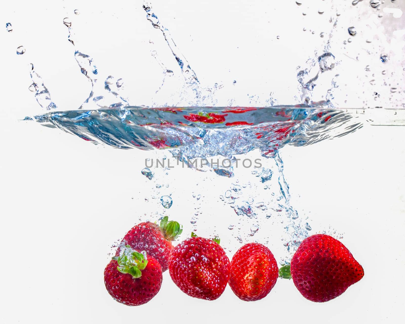 Ripe Strawberries Dropping Into Water