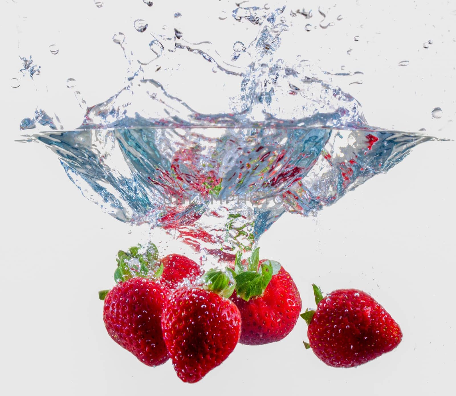 Ripe Strawberries Dropping Into Water