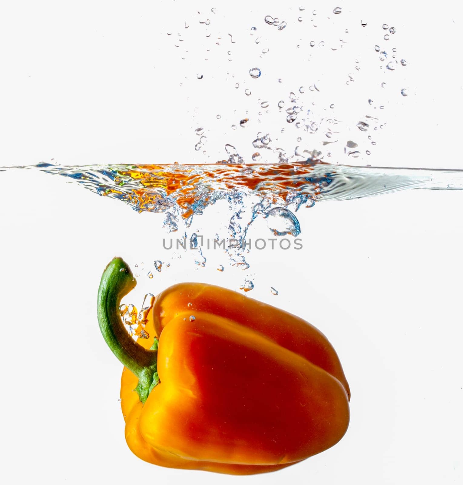 Orange Bell Pepper Dropping Into Water