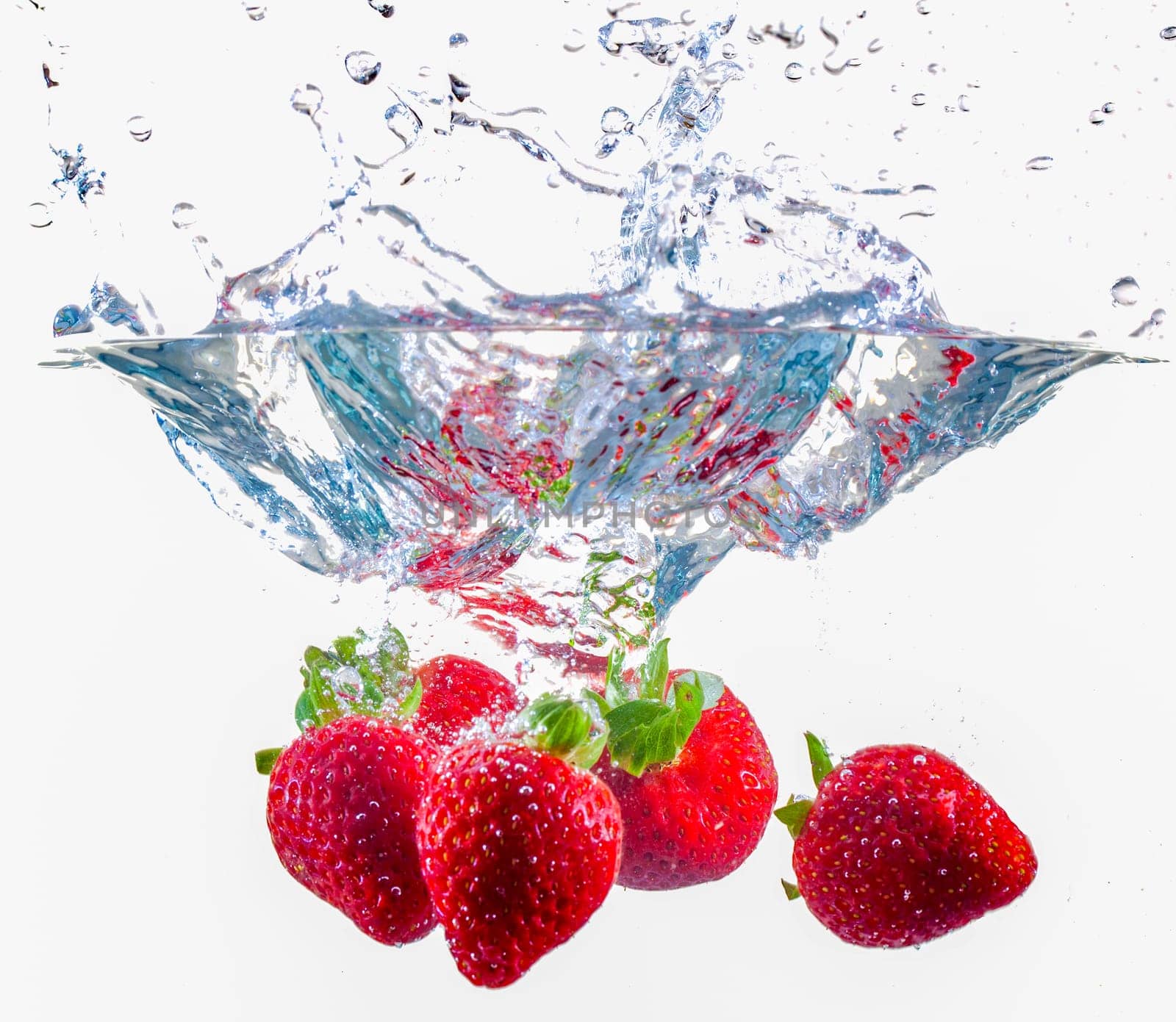Ripe Strawberries Dropping Into Water