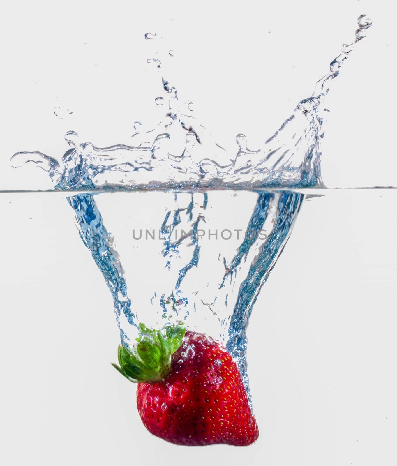 Ripe Strawberries Dropping Into Water