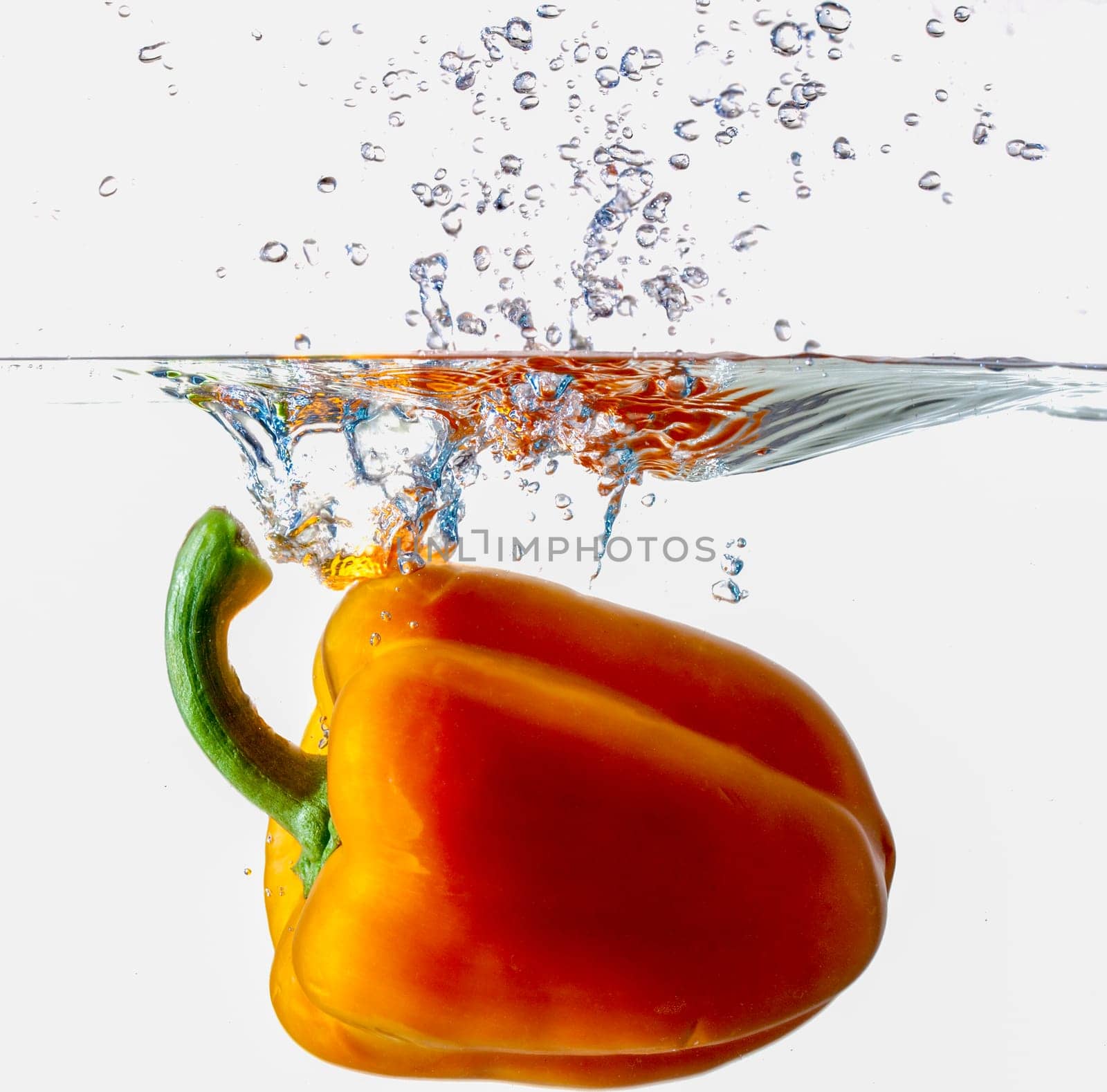 Orange Bell Pepper Dropping Into Water