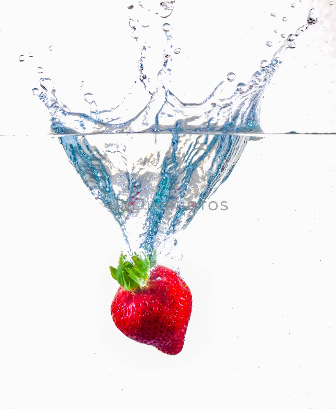 Ripe Strawberries Dropping Into Water