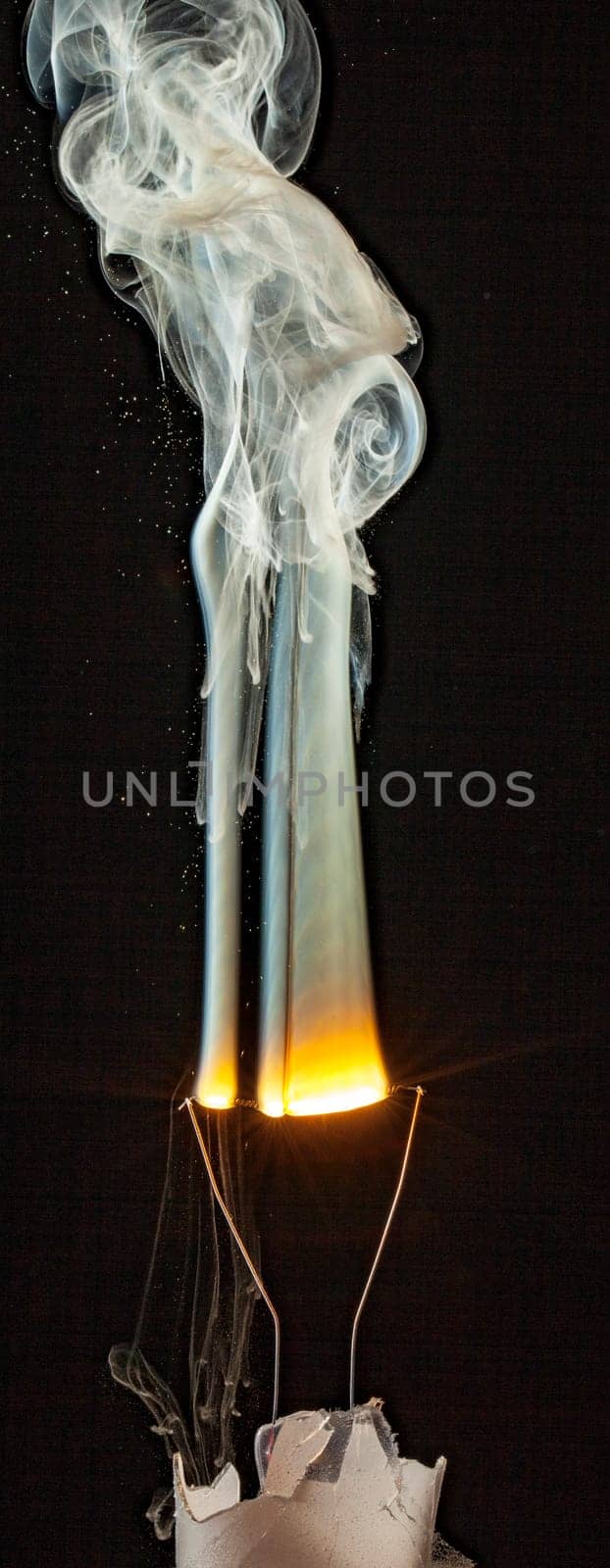 An electrical element in a light bulb igniting and burning out