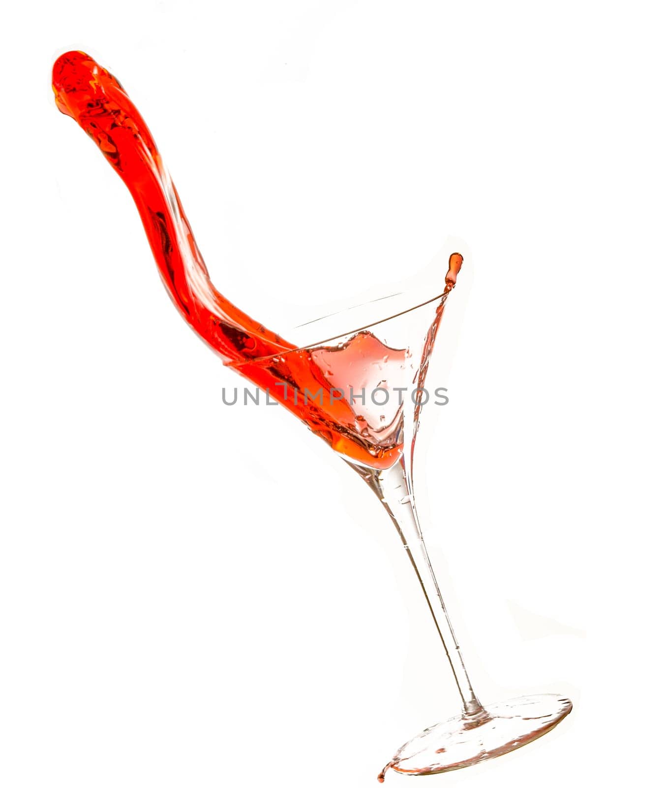 Wine being poured into glass, with slop spilling over.