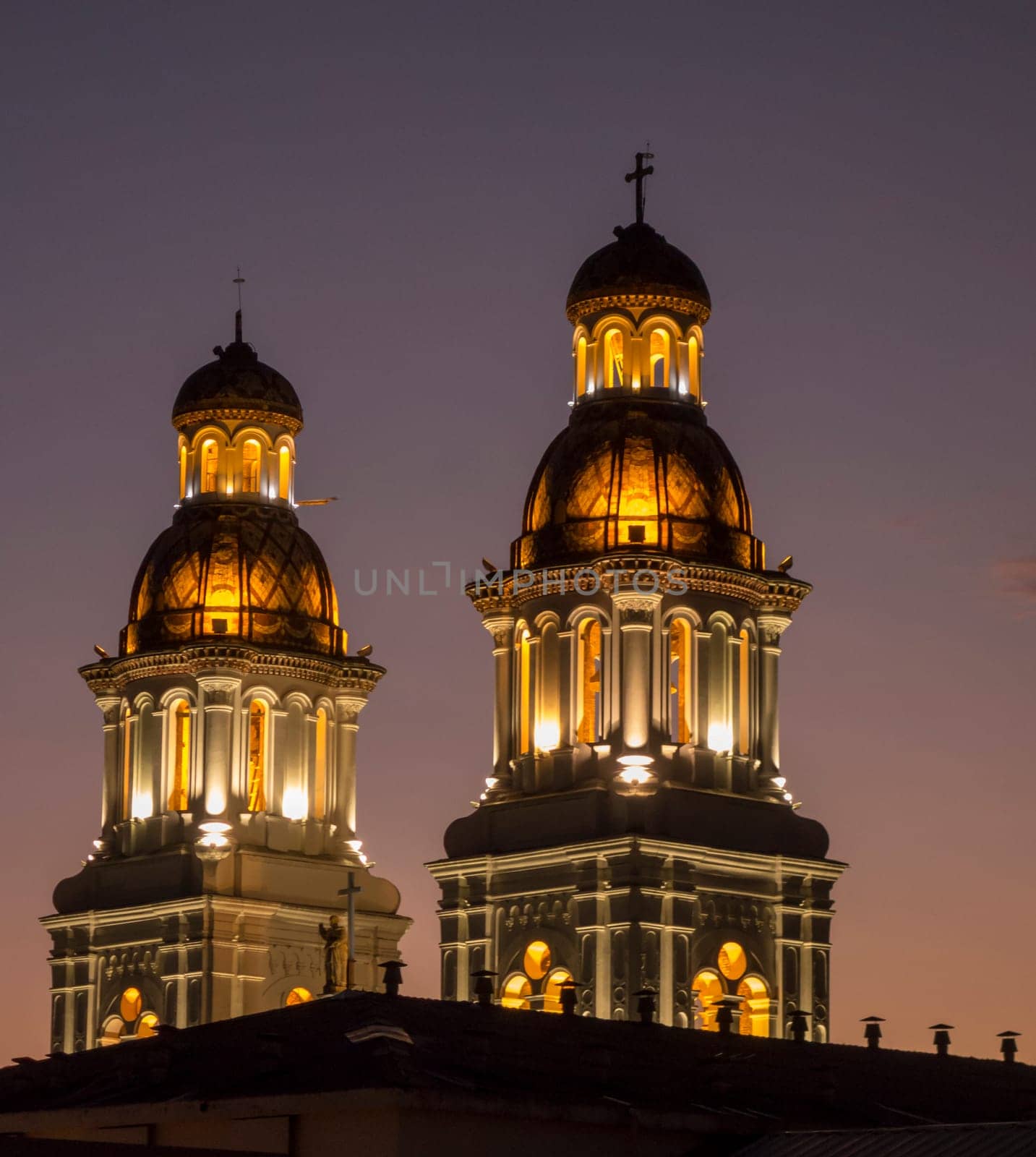 Illuminated towers of Iglesia Santo Domingo in Cuenca, Ecuador, at night