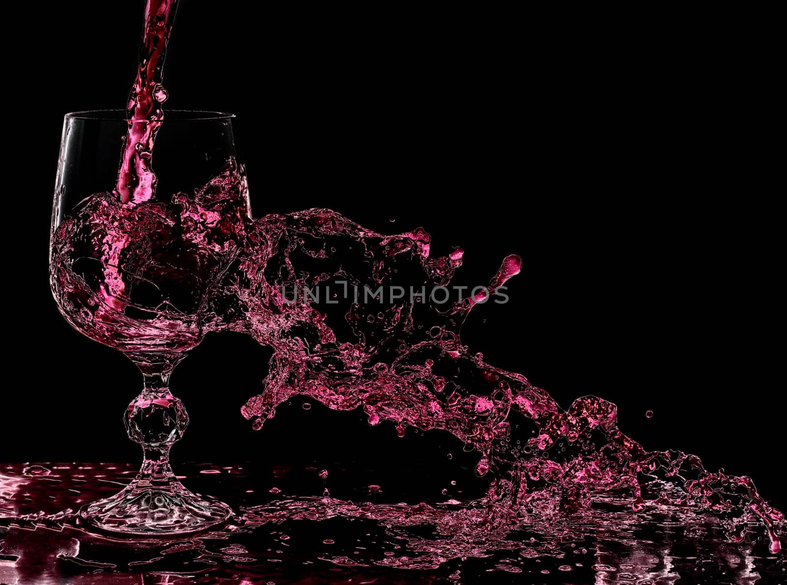 Wine splashes out of glass when poured