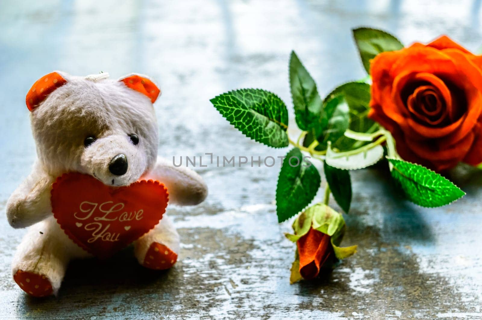 I Love You still life romantic theme background concept for valentine's day or friendship. Red rose flower and teddy bear on rustic floor. Wallpaper web banner design decoration. Copy space room for text for massage.