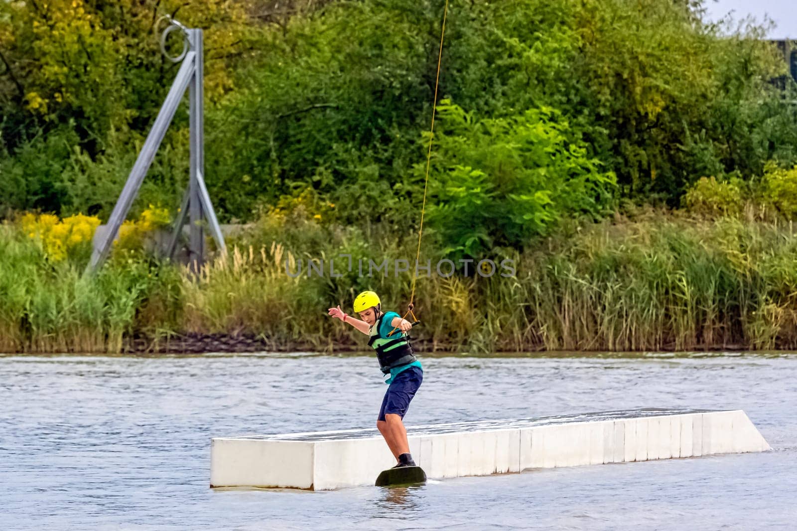 Teenager wakeboarding on a lake - Brwinow, Masovia, Poland