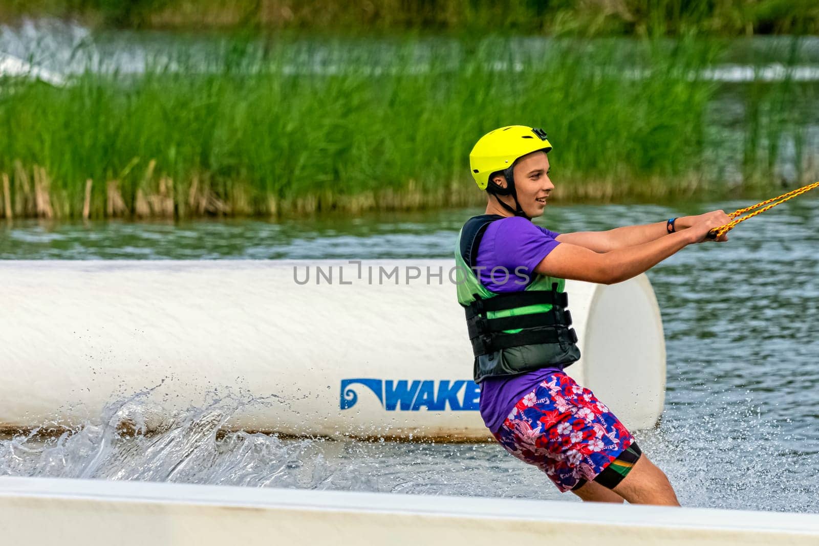 Teenager wakeboarding on a lake - Brwinow, Masovia, Poland