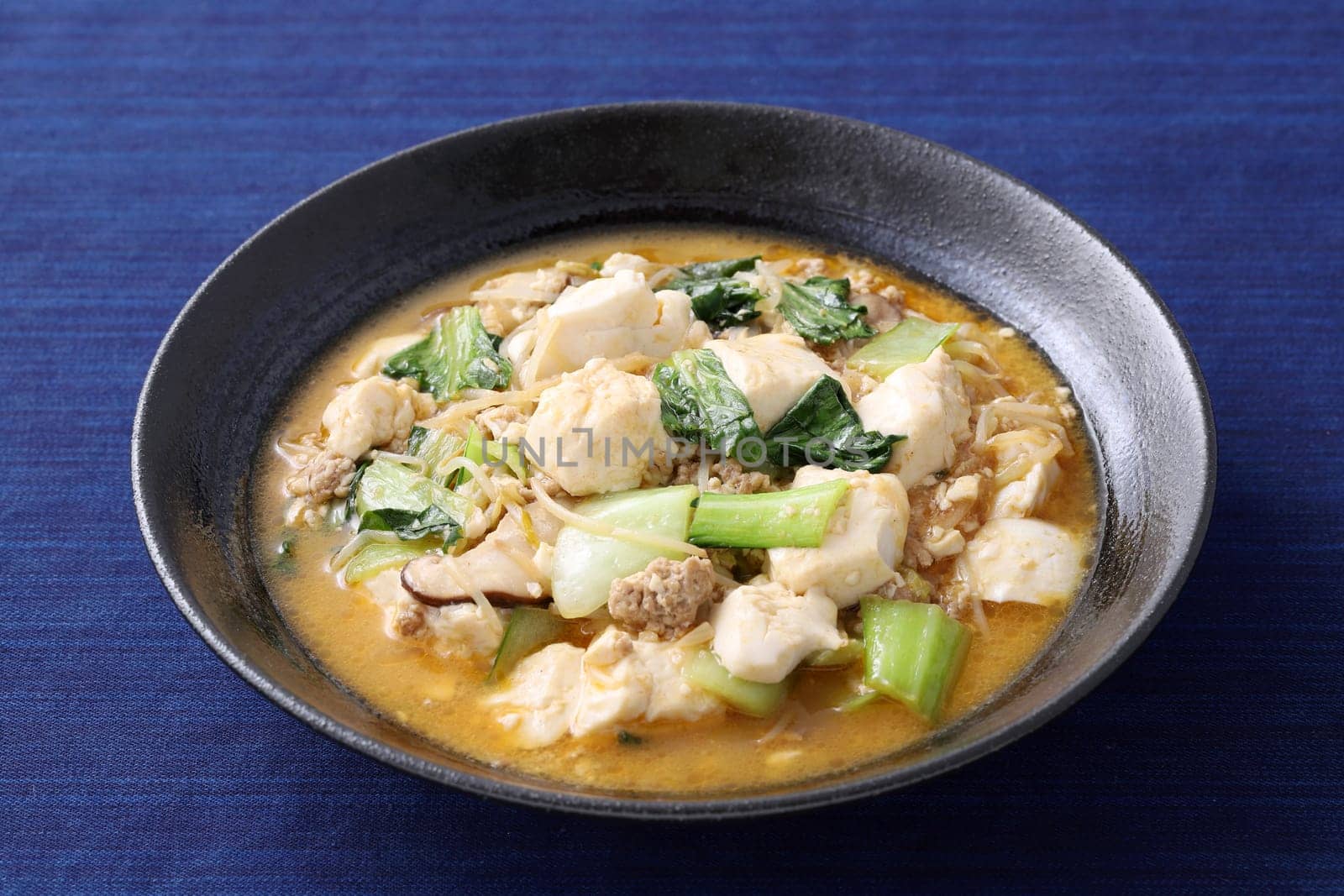 Chinese cuisine mapo tofu in a dish on wooden tray, Japanese style,