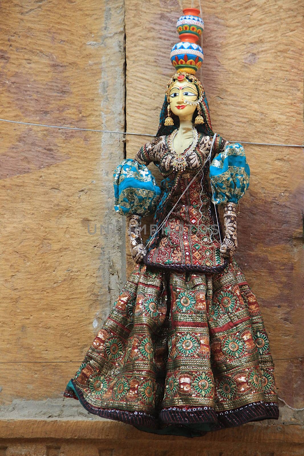 Rajasthani doll in colorful attire bearing pots on head dispalyed at Patawon-ki-Haweli in Jaisalmer Fort, Jaisalmer, Rajasthan, India, Asia