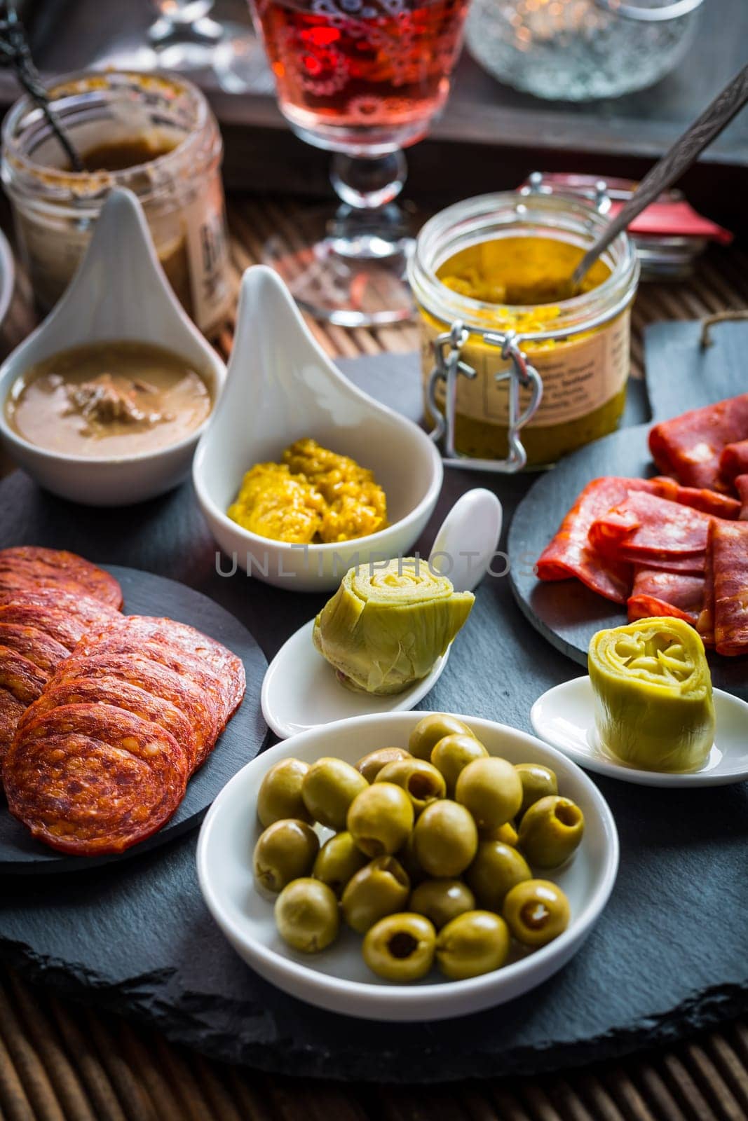 Assortment of tapas and antipasti on black background. Charcuterie boards of assorted appetizers.