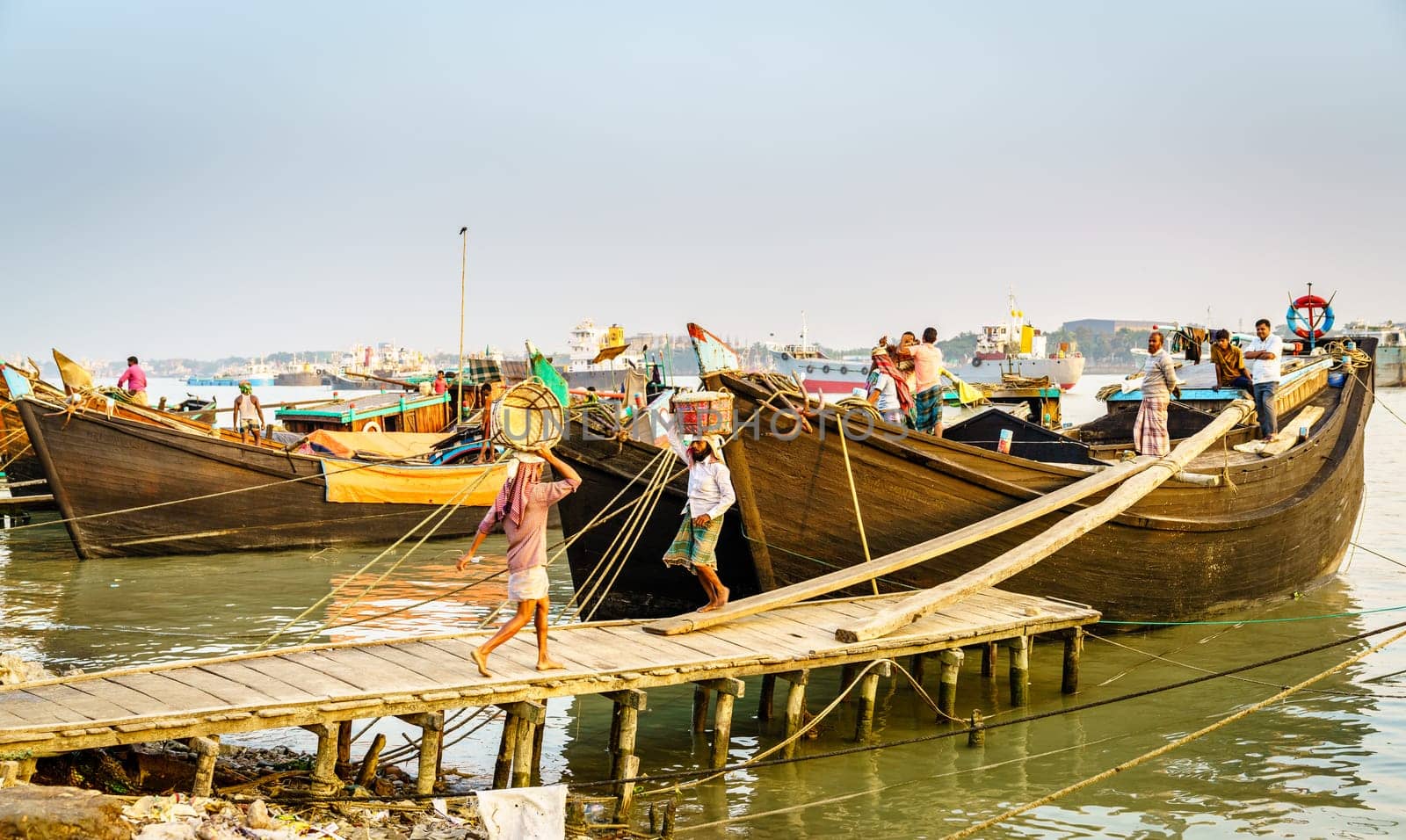 Chittagong, Bangladesh, December 22, 2017: Manual offloading of salt from a boat at the Karnaphuli River port in Chittagong, Bangladesh