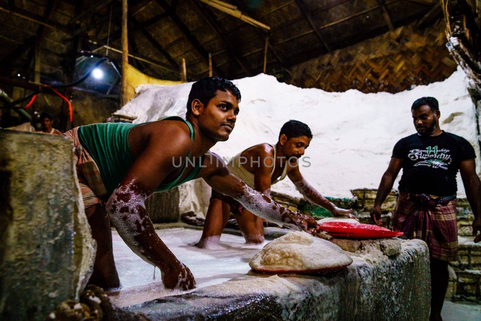 Chittagong, Bangladesh, December 22, 2017: Hard labor in a salt factory in Chittagong, Bangladesh