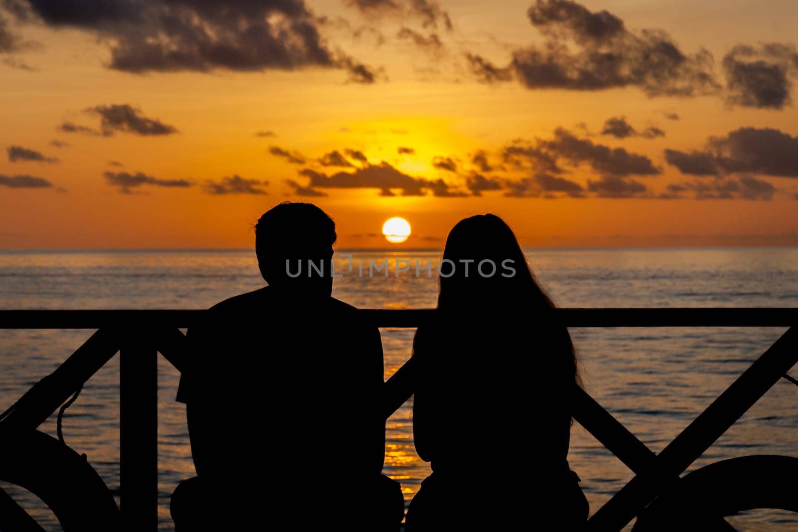 Sunset on the Maldives, a couple on the beach looking in the distance