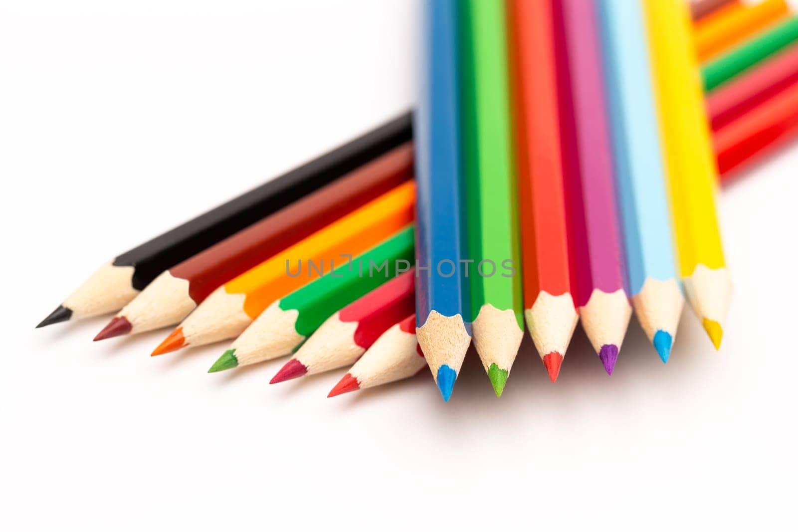 A wooden colored pencils of different colors on a white background