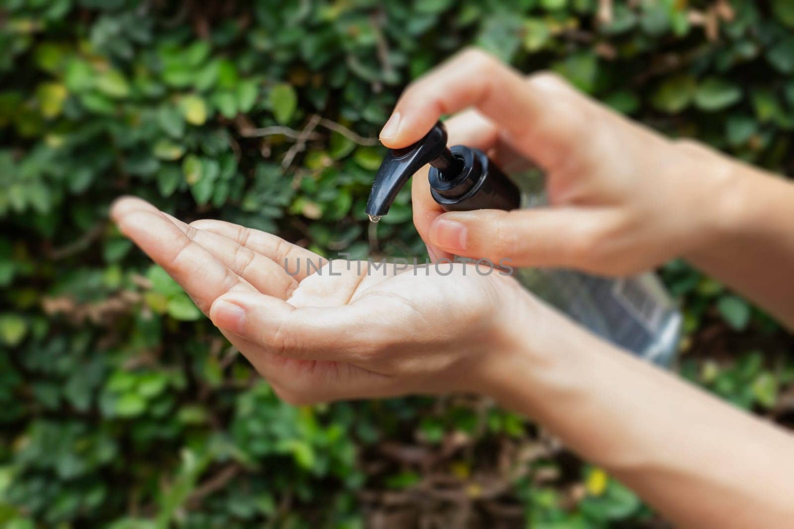 Woman hands using alcohol gel clean wash hand sanitizer anti virus bacteria, stock photo