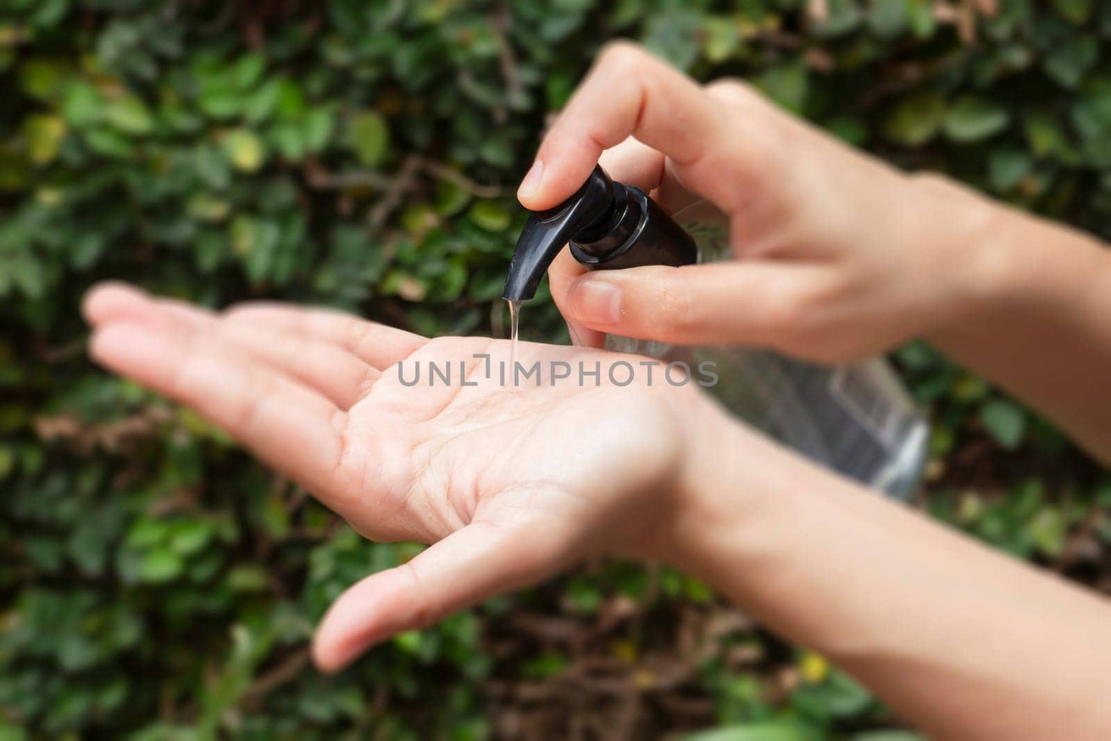 Woman hands using alcohol gel clean wash hand sanitizer anti virus bacteria, stock photo