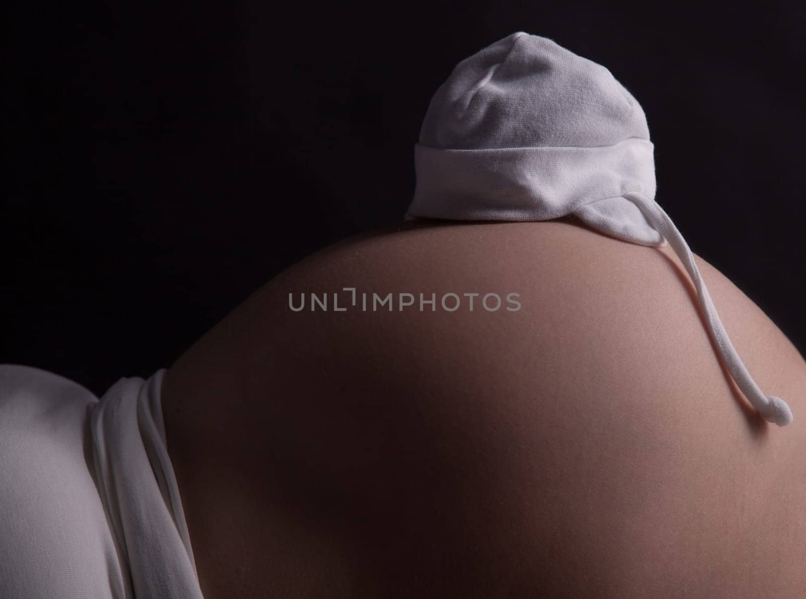 A belly of a pregnant woman, she is waiting for a miracle