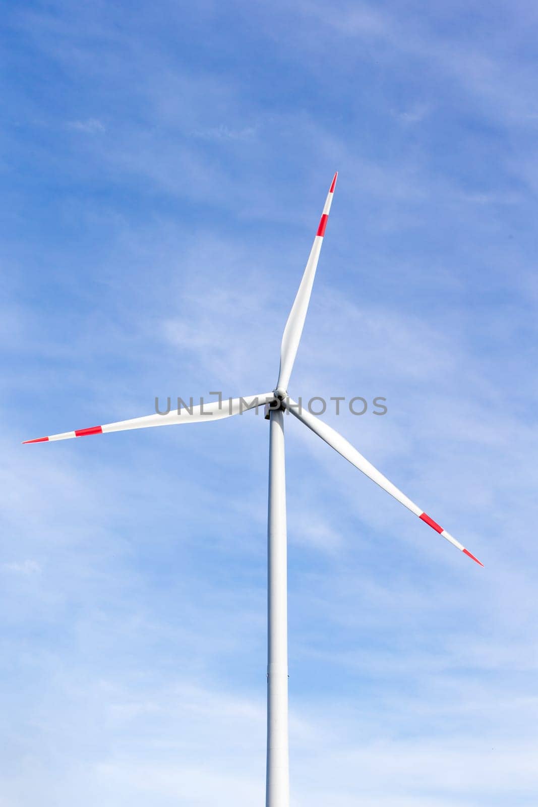 The windmill with a blue sky in the background