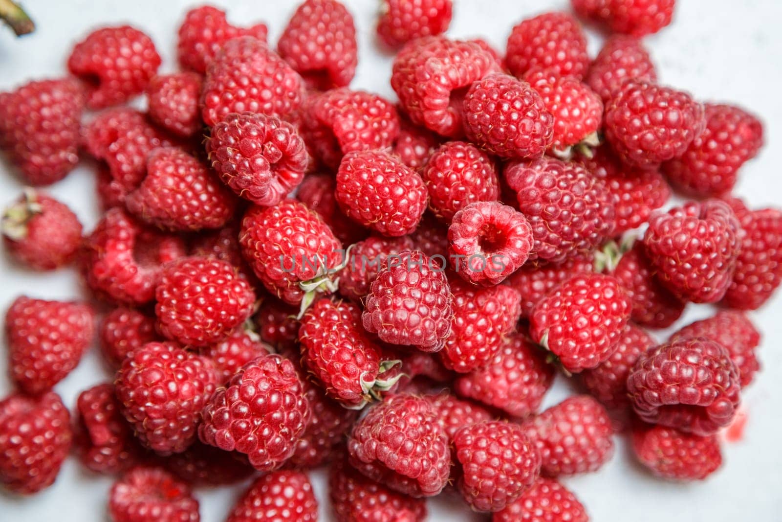 Fresh and sweet raspberries background.
