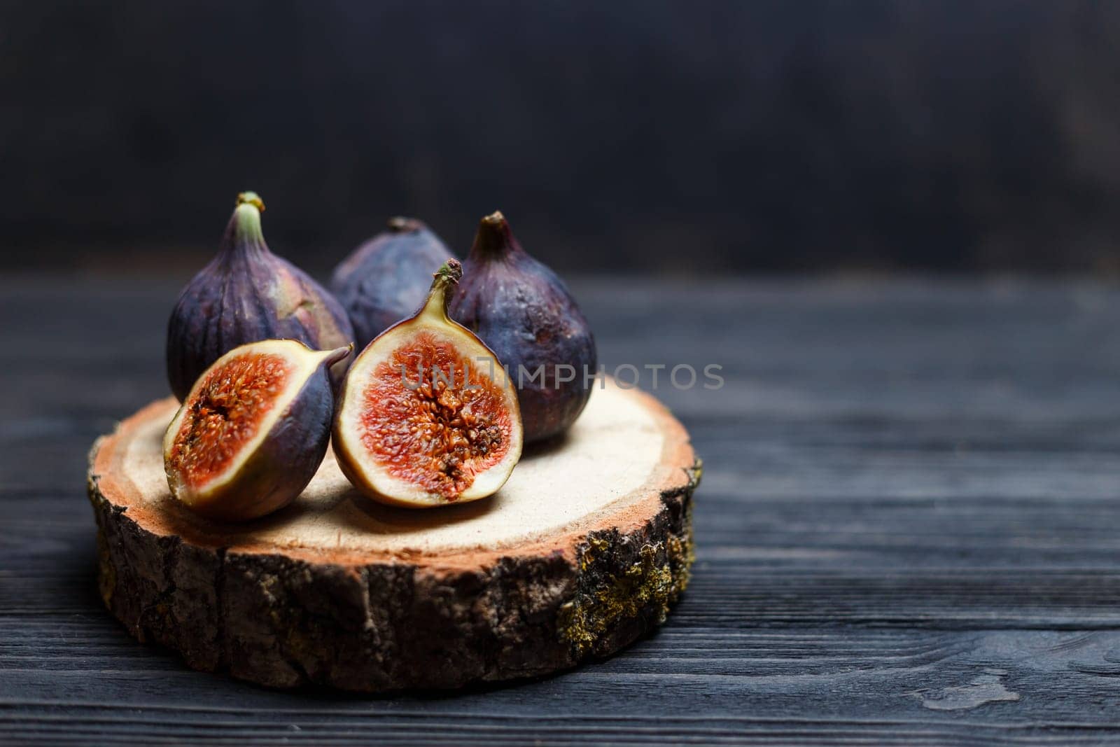 sliced fig fruits on a wooden board.