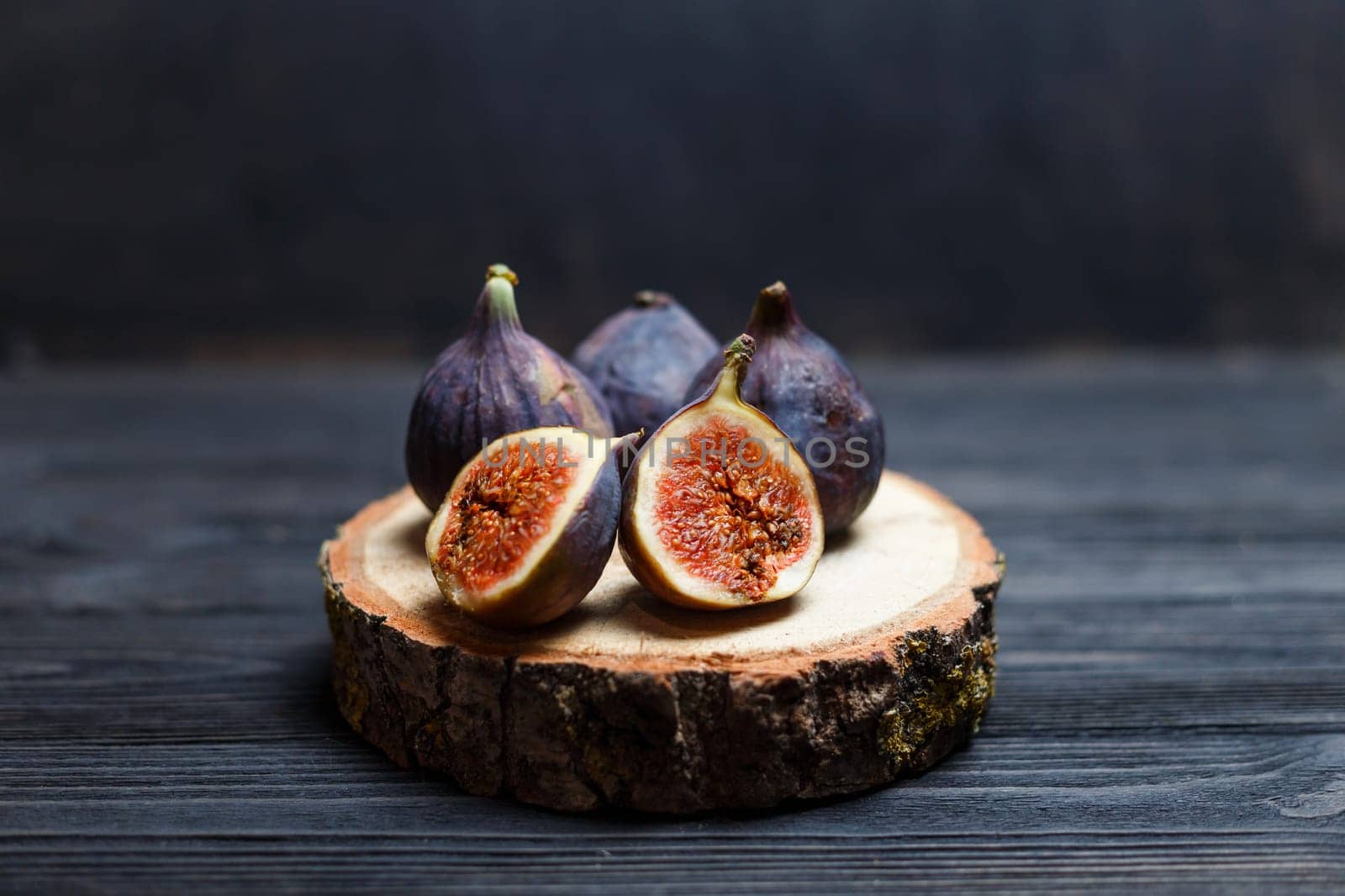 sliced fig fruits on a wooden board.