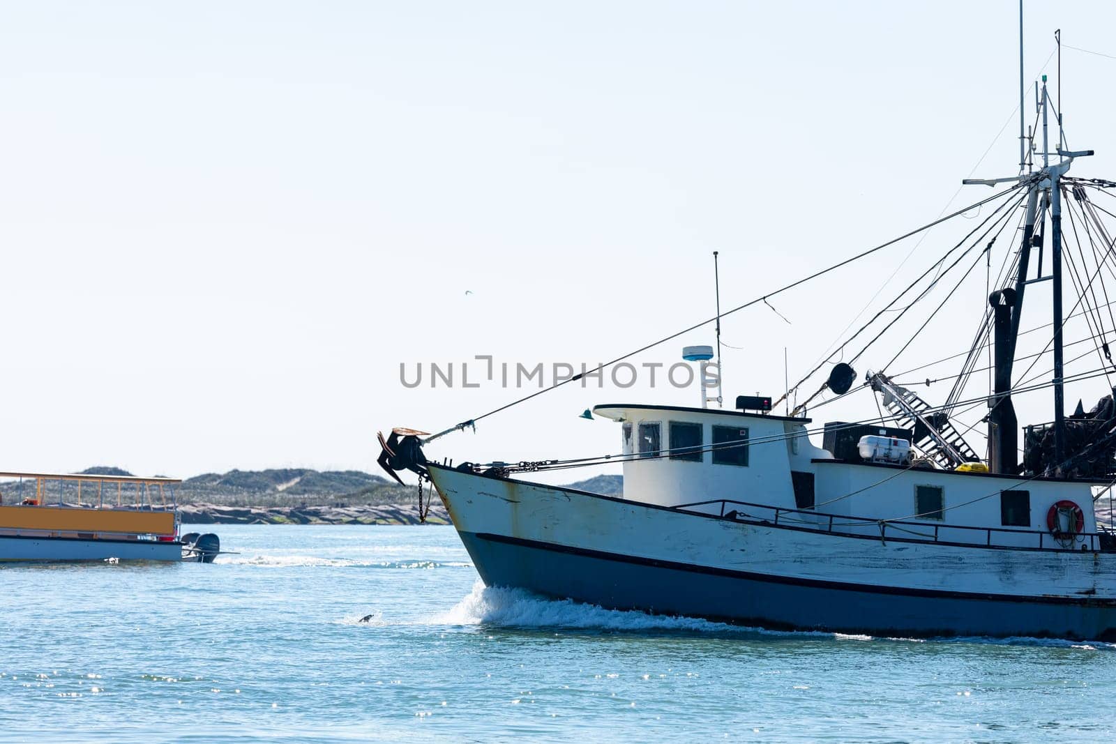 Old fishing boat navigating the Brazos Santiago Pass from the Laguna Madre into the Gulf of Mexico