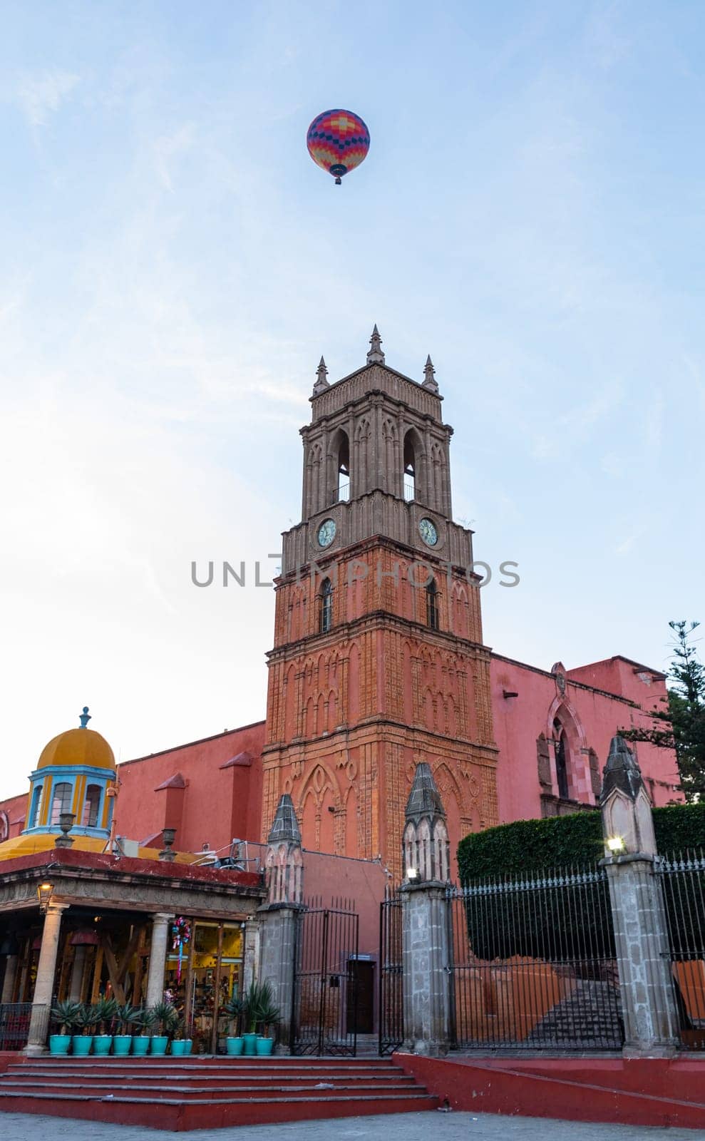 Hot air balloon flying over La Santa Escuela de Cristo early in the morning, in San Miguel de Allende, Guanajuato, Mexico