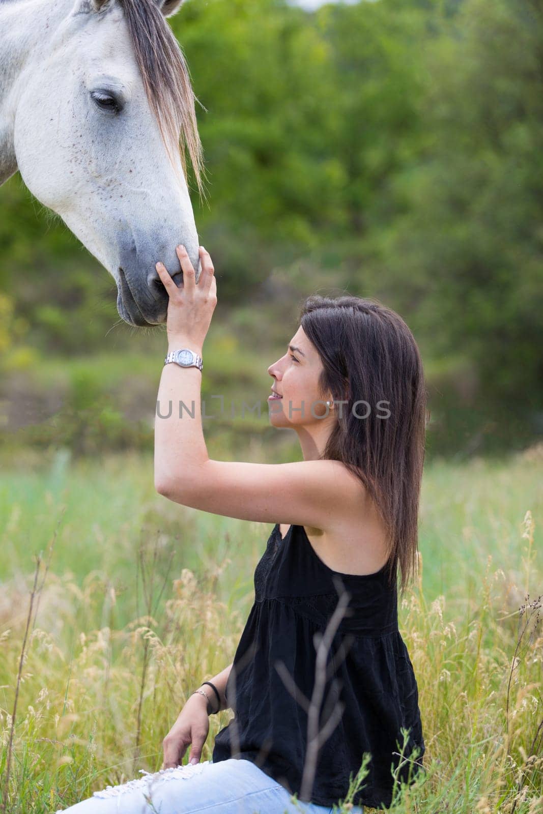 Happy young woman with her horse and strolling