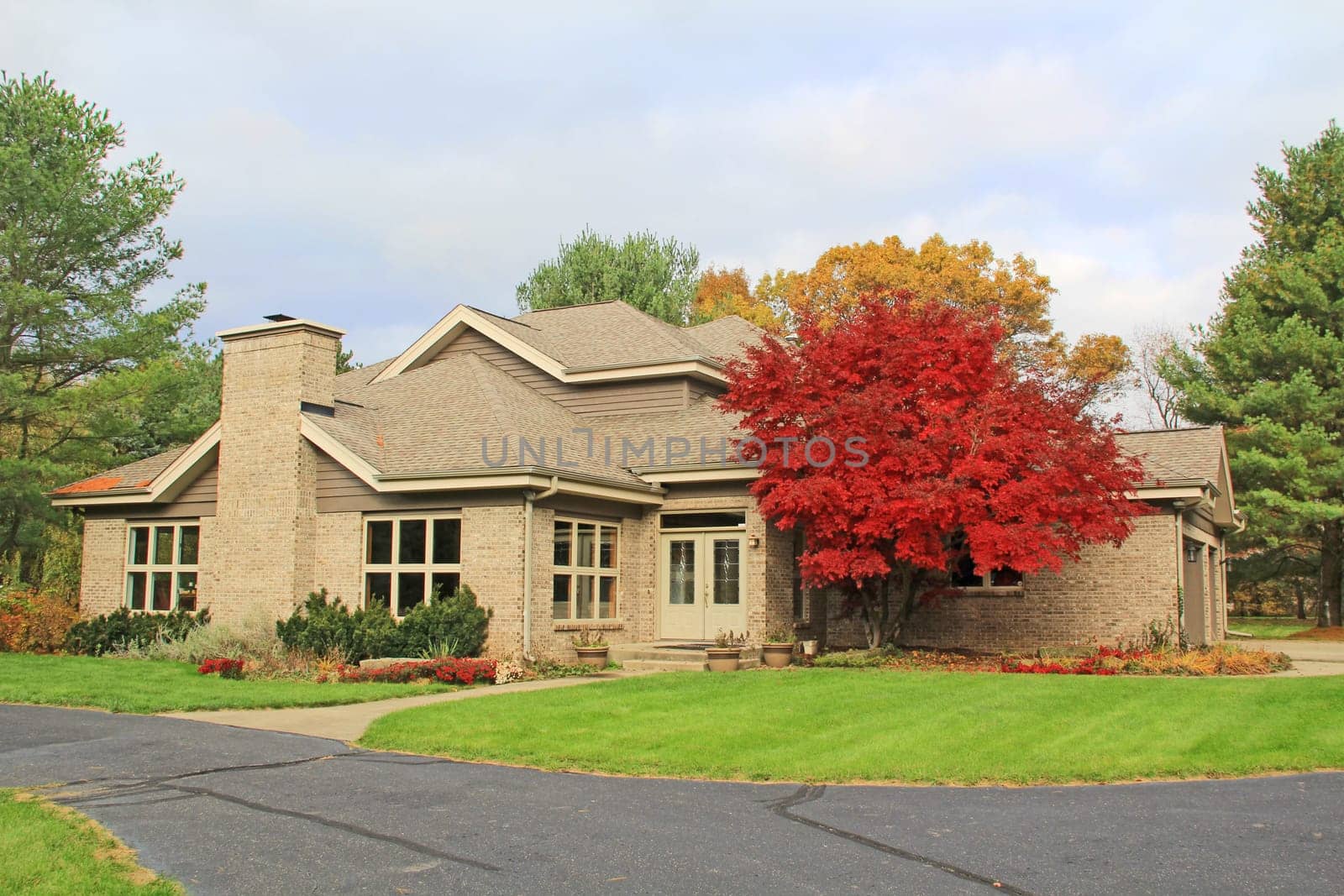 Single family brick contemporary home with a circle drive.