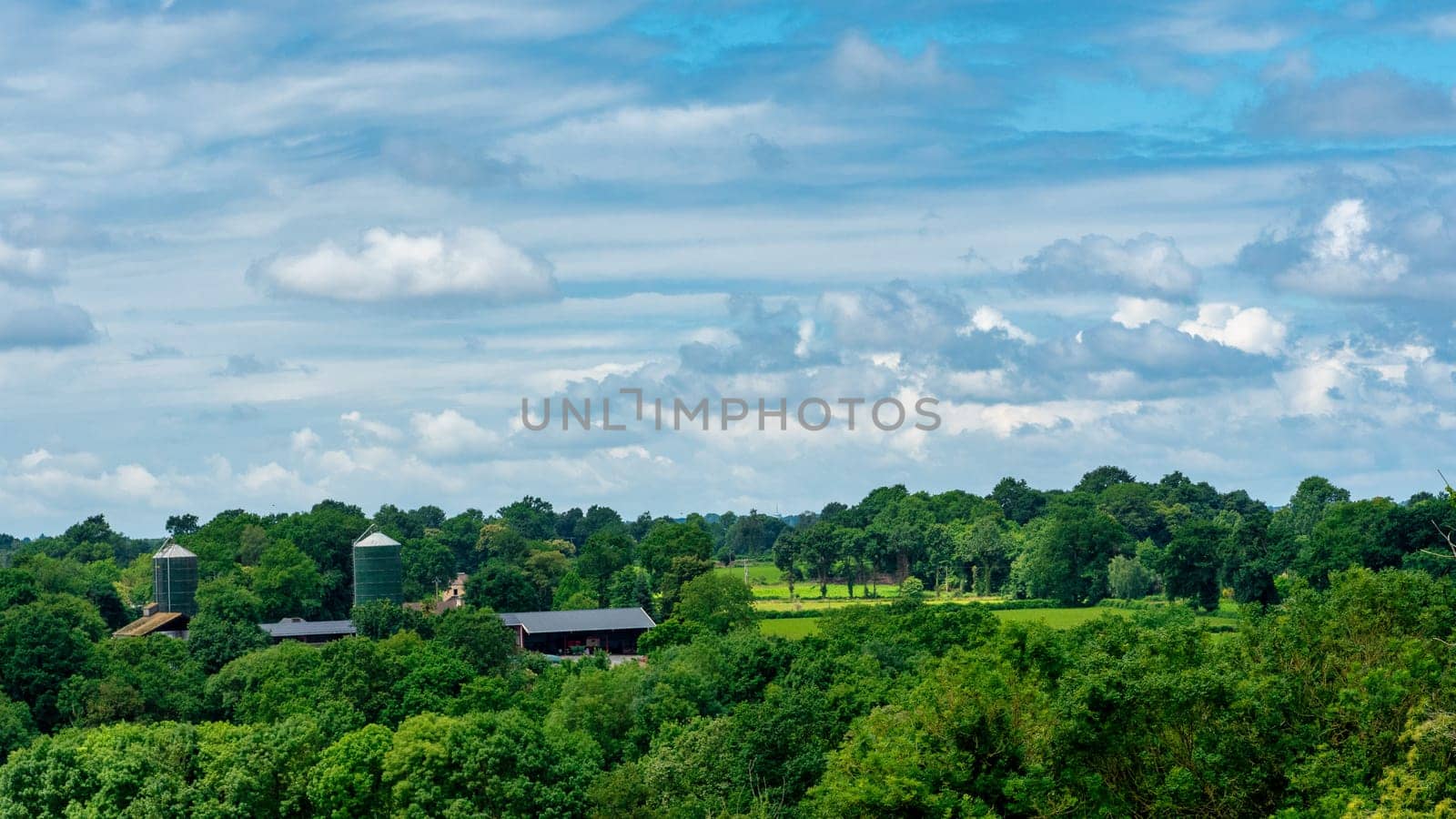 a panorama of french countryside with farm