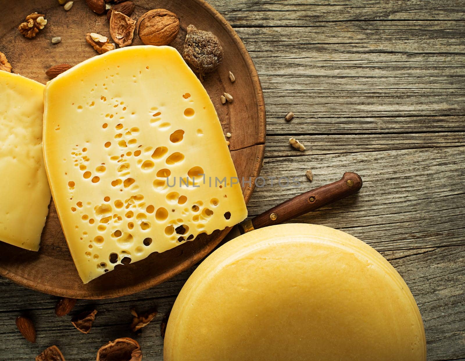 Various kind of hard cheese served on wooden table, traditional pieces of hand-made cheese. Copyspace for text