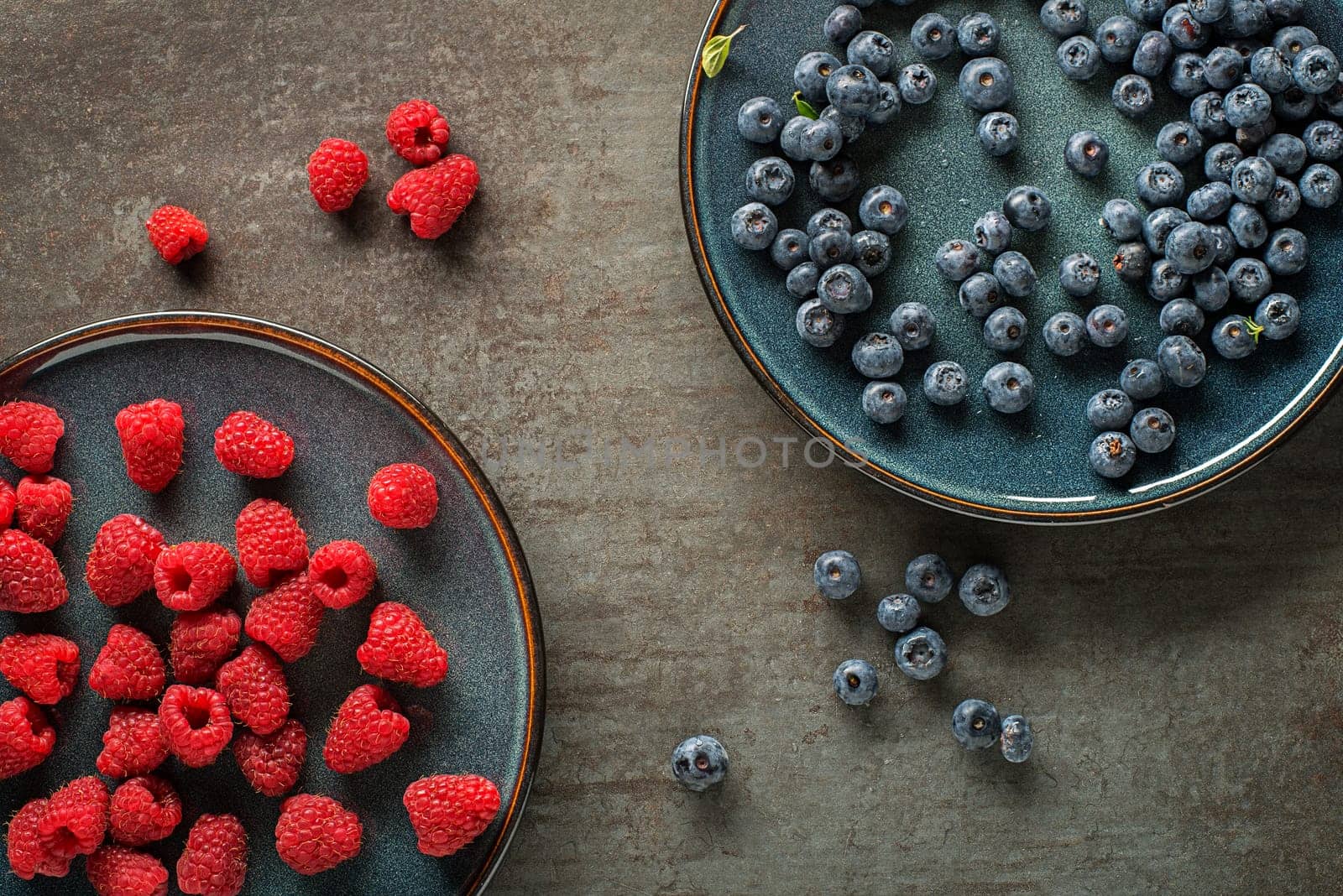 Colorful assorted of blueberry and raspberry. Berries overhead closeup