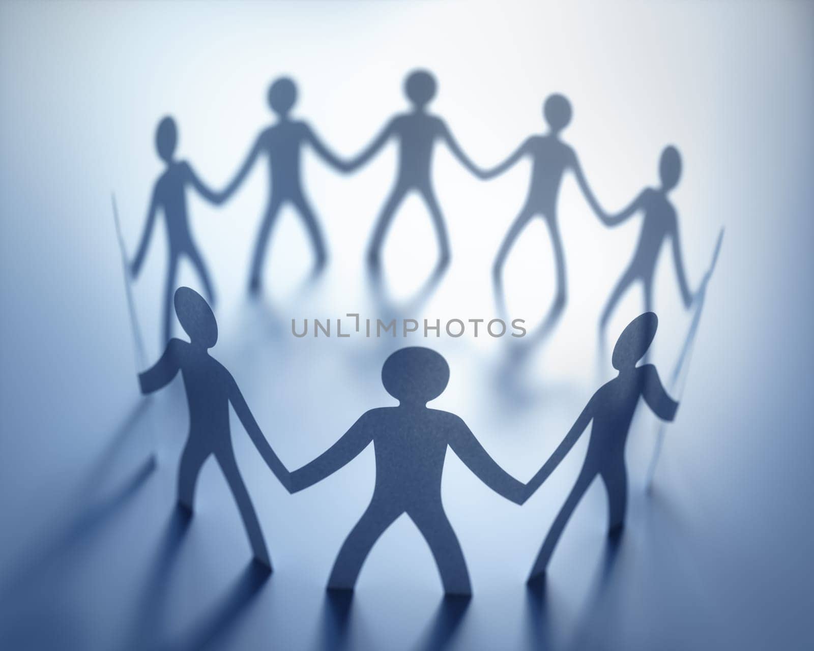 Group of people, united in the meeting of an organization. Paper cut out in the shape of people.