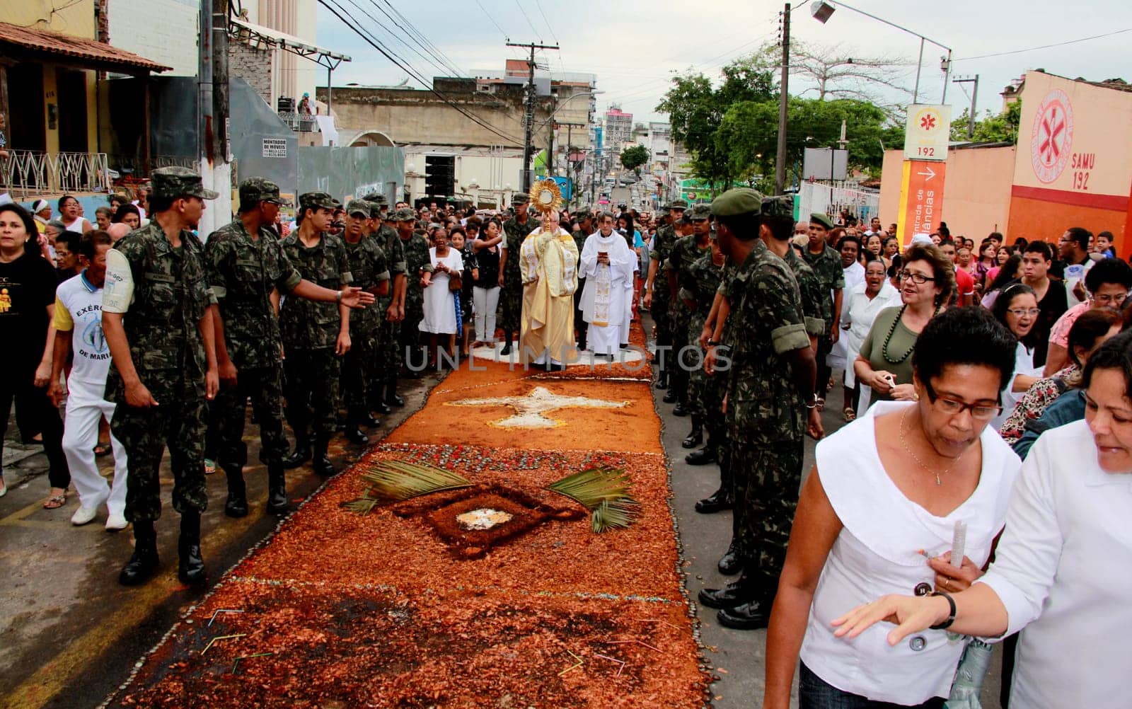 Itabuna, Bahia / Brazil - June 7, 2012: People are seen during procession upon traditional tapes during the Corpus Crist holiday festivities in Itabuna.