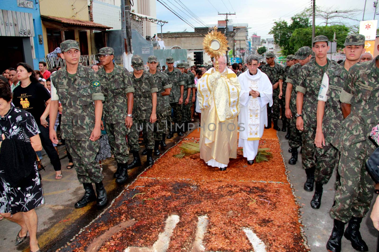 Itabuna, Bahia / Brazil - June 7, 2012: People are seen during procession upon traditional tapes during the Corpus Crist holiday festivities in Itabuna.