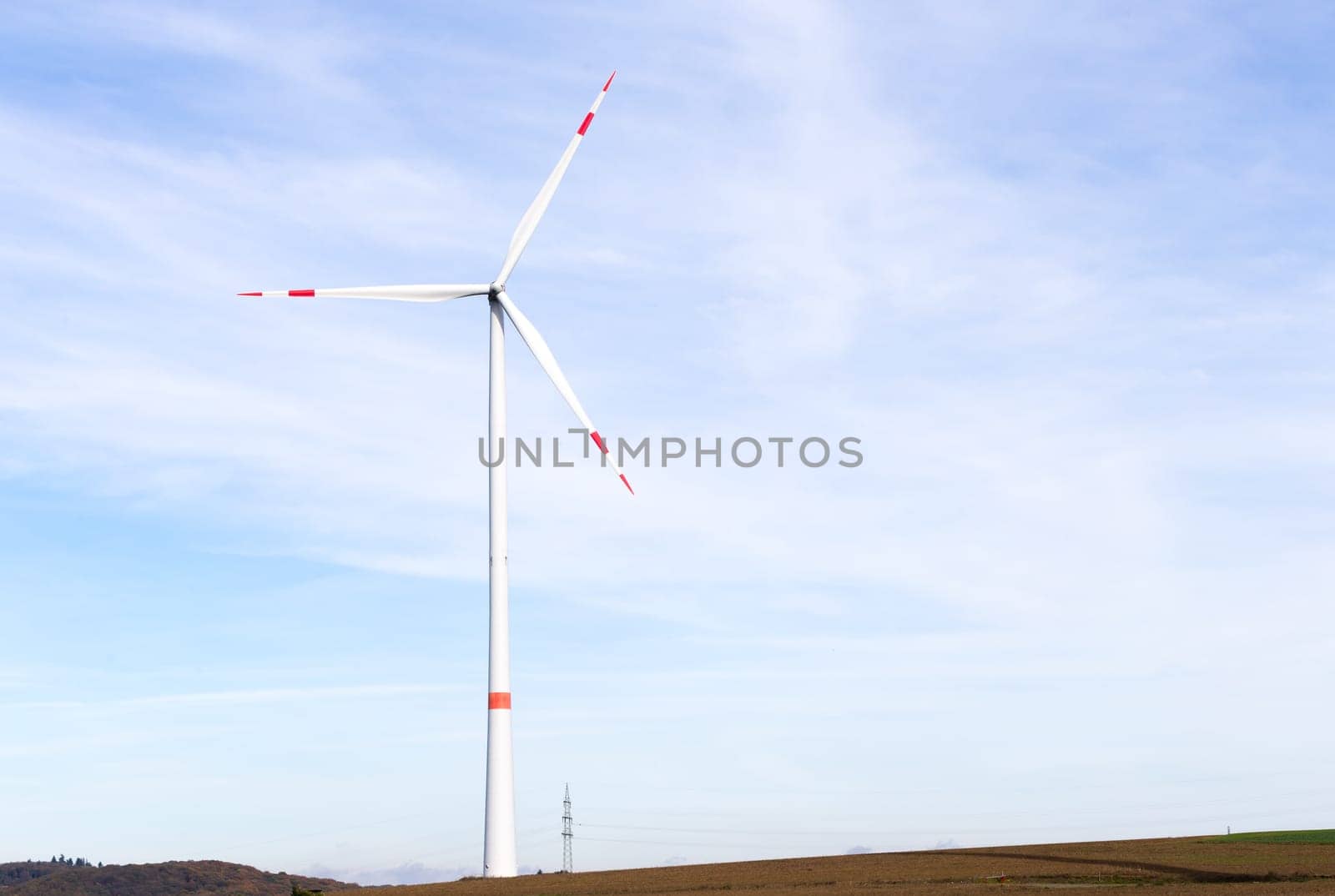 The windmill on a field with blue sky