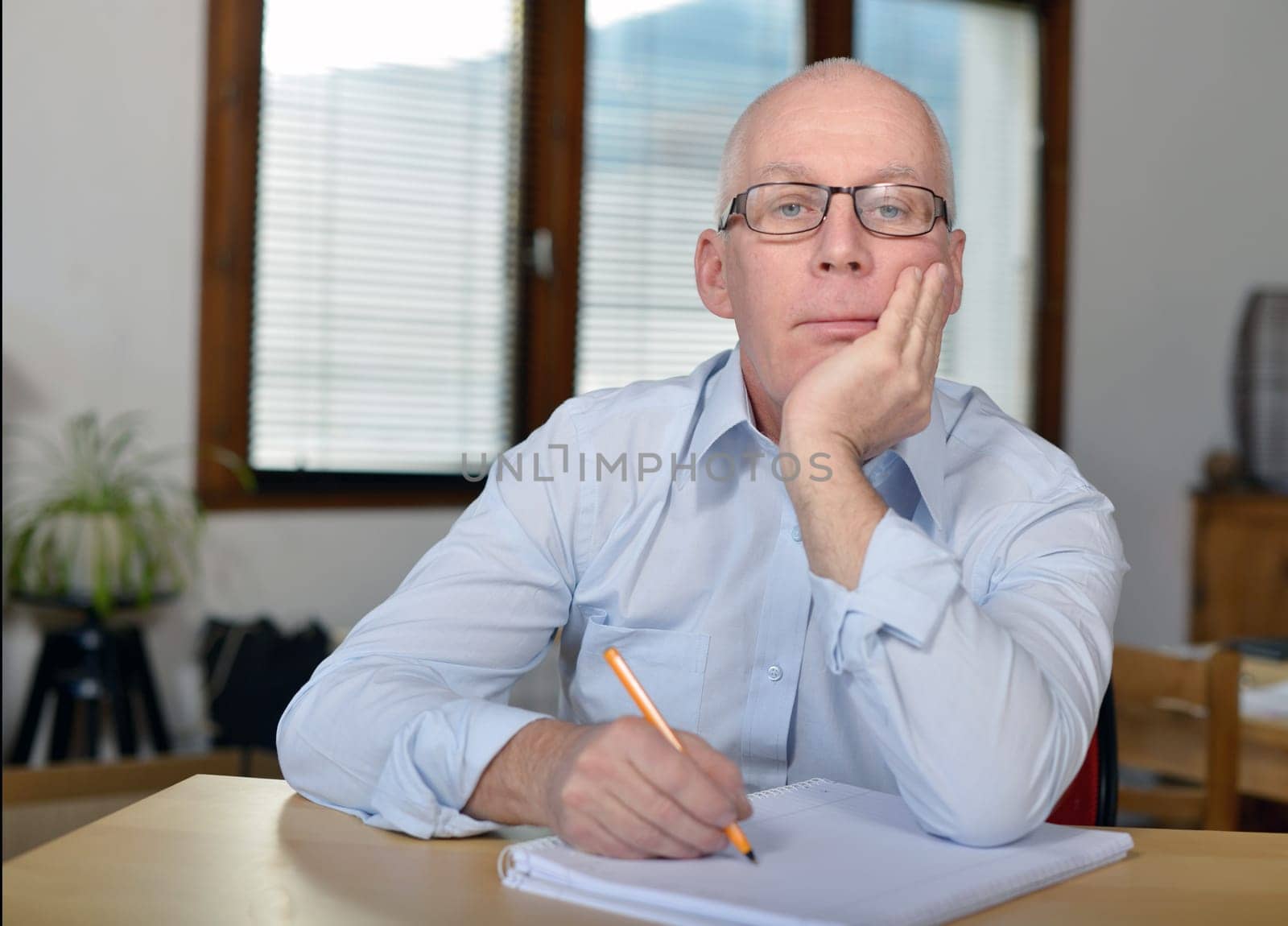 a serious mature businessman in office