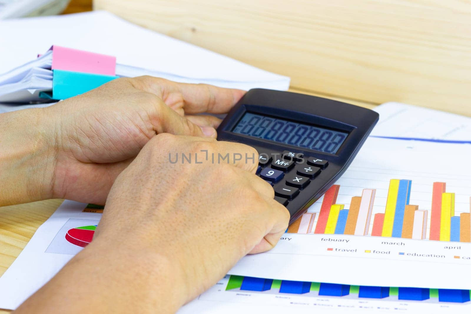 Employees use office calculators with documents of income, expenses, concept of life at work.