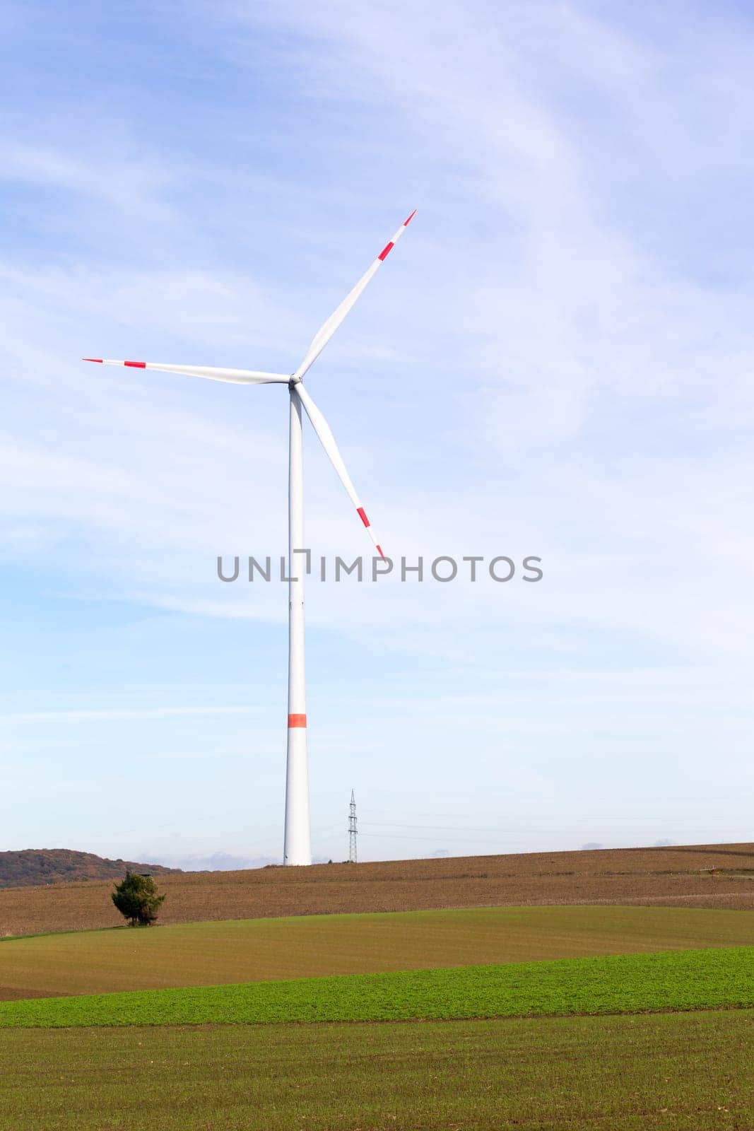 The windmill on a field with blue sky