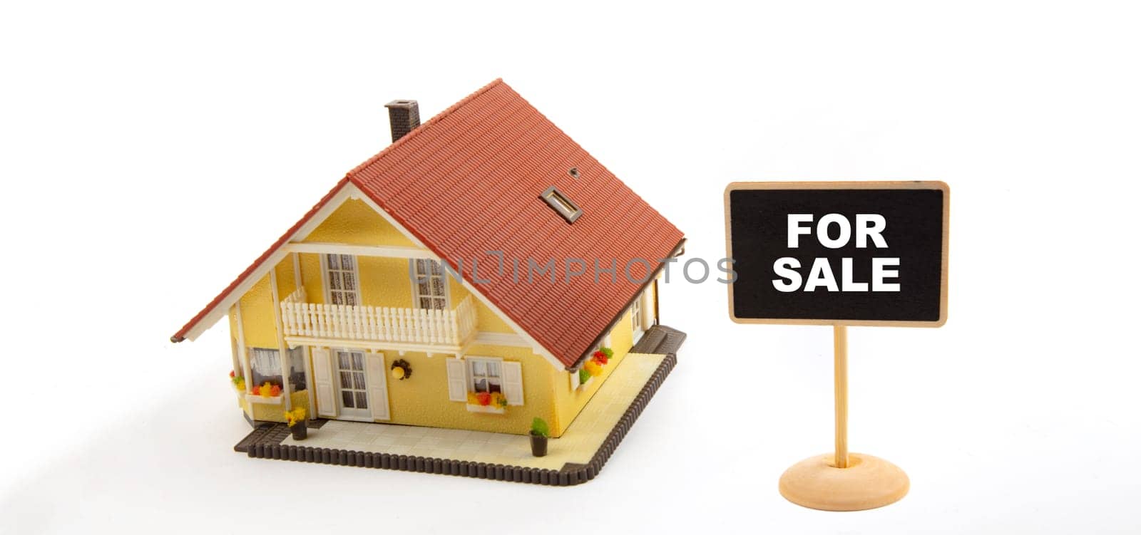For Sale, Concept Business Real Estate with Toy House and little Blackboard Sign on white Background