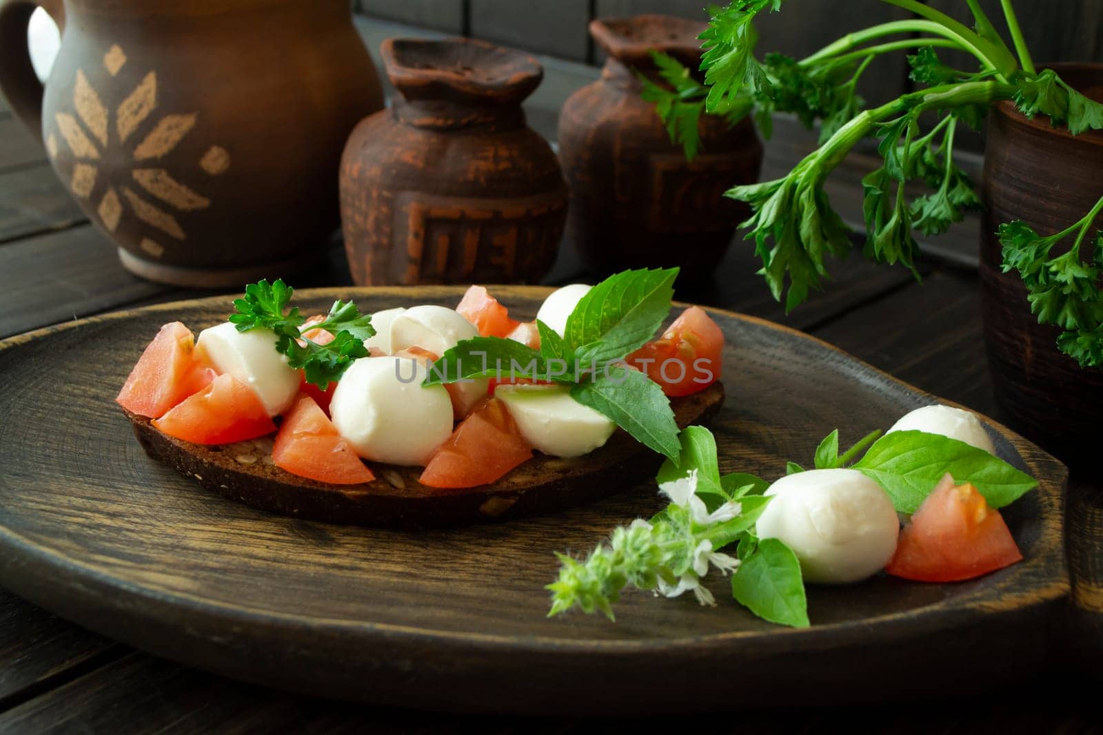 Bruschetta with tomatoes, mozzarella and basil. Traditional italian appetizer or snack